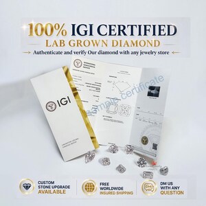 May include: An IGI certified lab grown diamond report document with a gold foil accent, accompanied by several loose, faceted, clear, colorless, brilliant-cut diamonds of various shapes scattered on a plain white surface with informational text.