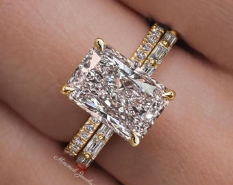 May include: A gold ring set featuring a large rectangular radiant-cut centre stone held by four prongs. The band is adorned with small round and baguette-cut stones. The text Minimal Jewelry is visible on the lower left side of the ring band.