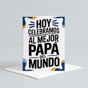May include: A white greeting card with the text "HOY CELEBRAMOS AL MEJOR PAPA DEL MUNDO" in black, with blue and orange decorative elements. The card is on a white envelope.