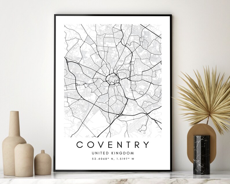 May include: Black and white map print of Coventry, United Kingdom. The map shows the city streets and landmarks. The text "COVENTRY" and "UNITED KINGDOM" are printed below the map, along with the coordinates "52.4068&deg; N, 1.5197&deg; W".