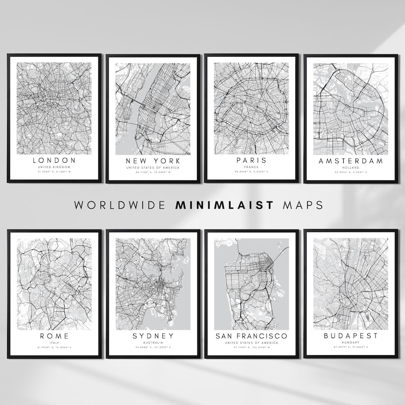 May include: A set of eight minimalist city maps in black frames. The maps are printed on a light grey background with black lines representing streets and roads. The cities featured are London, New York, Paris, Amsterdam, Rome, Sydney, San Francisco, and Budapest.