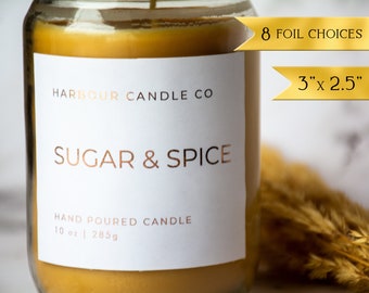 May include: A clear glass jar candle with a white label that reads "HARBOUR CANDLE CO" and "SUGAR & SPICE". The candle is hand-poured and weighs 10 ounces or 285 grams. The label also states that there are 8 foil choices and the candle is 3 inches by 2.5 inches.