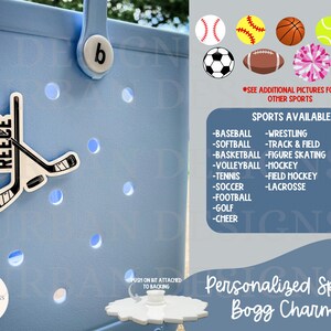 May include: A light blue personalized sports bag charm with a hockey stick and the name "Reece" on it. The charm is attached to a white plastic base. The image also shows a variety of sports charms, including baseball, softball, basketball, soccer, football, and more. The text "Personalized Sports Bogg Charms" is displayed at the bottom of the image.