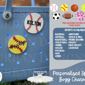 May include: Personalized sports-themed Bogg charms with names "Kolton" and "Paisley" on a blue tote bag. The charms are shaped like baseballs and softballs. The image also shows a list of sports available for customization.