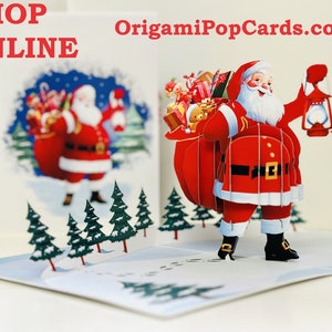 May include: A 3D pop-up Christmas card featuring Santa Claus carrying a bag full of presents and a lantern. The card is set against a snowy forest backdrop.  Shop online at OrigamiPopCards.com.