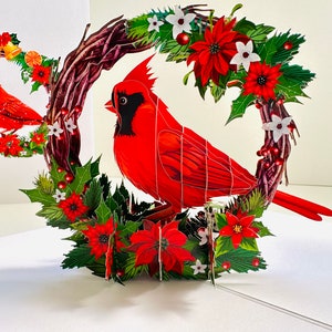 Joyeuses fêtes oiseau rouge cardinal avec couronne de fleurs rouges poinsettia 3D - Boutique de cartes de vœux pop-up https://origamipopcards.com/ Joyeux Noël
