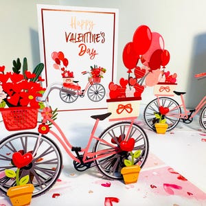 Joyeuse Saint-Valentin - Un beau vélo avec des fleurs et des cadeaux - Carte de voeux 3D ACHETER en ligne https://origamipopcards.com/