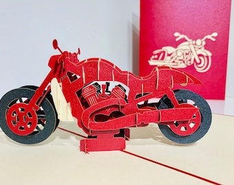 May include: Red papercraft motorcycle pop-up card. The motorcycle is detailed with a black engine and wheels.