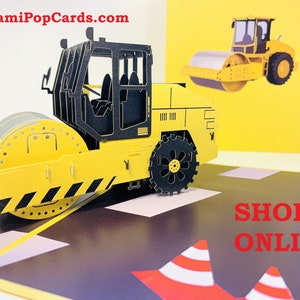 Caminhão rolo compressor constrói uma cidade perfeita para trabalhadores da construção civil e crianças. Cartão comemorativo pop-up 3D. Cartões pop-up de origami. https://origamipopcards.com/