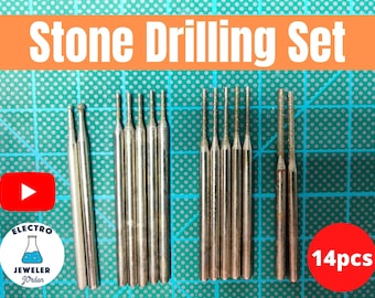 May include: A set of 14 silver stone drilling bits. The bits are arranged in two rows on a green surface. The text "Stone Drilling Set" is in the upper part of the image. The text "14pcs" is in the lower right corner of the image.