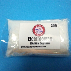 May include: A white plastic bag containing a white powder labeled "Electroclean Alkaline Degreaser" with a red and white logo that says "Lustro Electro" and the text "Makes 2000ml" and the website "www.electrojewelerjordan.com".