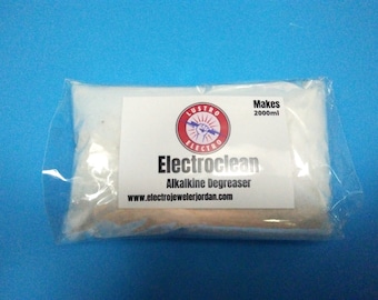 May include: A white plastic bag containing a white powder labeled "Electroclean Alkaline Degreaser" with a red and white logo that says "Lustro Electro" and the text "Makes 2000ml" and the website "www.electrojewelerjordan.com".