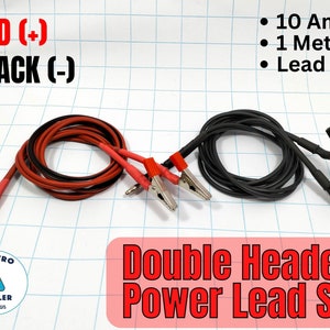 May include: A set of two double-headed power leads, one red and one black, with alligator clips on both ends. Each lead is 1 meter long and rated for 10 amps. The leads are lead-free. The text "RED (+)" and "BLACK (-) " is visible in the top left corner of the image. The text "Double Headed Power Lead SET" is visible in the bottom right corner of the image.