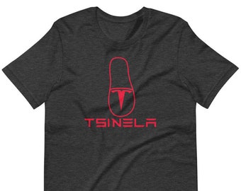 May include: Dark heather grey t-shirt with a red Tesla logo and the text "TSINELA" printed on the front.