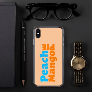 May include: A clear phone case with a peach background and the words "Peach Pie Mango" in blue and orange text.