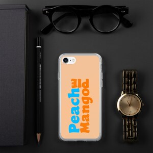 May include: A clear phone case with a peach background and the text "Peach Mango" in blue and orange letters.