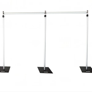 May include: A silver telescoping backdrop stand with three adjustable poles and black square bases. The stand is used to display backdrops for photography or events.