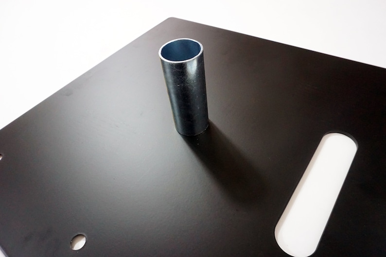 May include: Black metal square base with a silver metal pipe in the center. The base has a rectangular cutout on the right side.