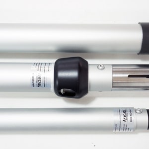 May include: Three silver telescoping poles with black end caps. The middle pole has a silver connector with a black cap and a label that reads "ANYCASE MADE IN CHINA".