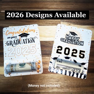 May include: Two graduation gift card holders with rolled-up money inside. One says "Congratulations on your GRADUATION 2025" with a graduation cap graphic. The other says "HAPPY GRADUATION 2025" with a graduation cap graphic. The text "2026 Designs Available" is at the top.