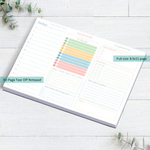 May include: A white 8.5x11 inch tear-off notepad with a colorful daily planner layout. The notepad features sections for to-do lists, priorities, and notes. Text includes "Today", "Self Care Today", and "50 Page Tear Off Notepad".