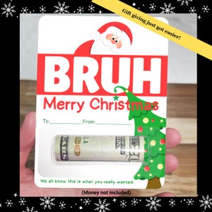 May include: A Christmas gift card with the word "BRUH" in large red letters, and "Merry Christmas" below. The card features a Santa Claus illustration and a green Christmas tree. A rolled-up wad of cash is visible. Text reads "We all know this is what you really wanted."
