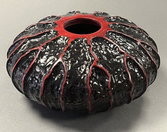 Textured, decorative, hand turned black wooden pot with contrasting red ridges. Unique.