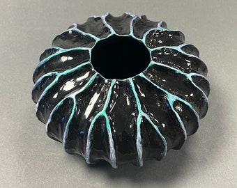 Textured decorative hand turned black wooden pot with beautiful iridescent blue ridges.