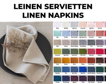 May include: A folded linen napkin in a natural color on a black plate. A color chart of 43 different linen napkin colors is shown in the background.