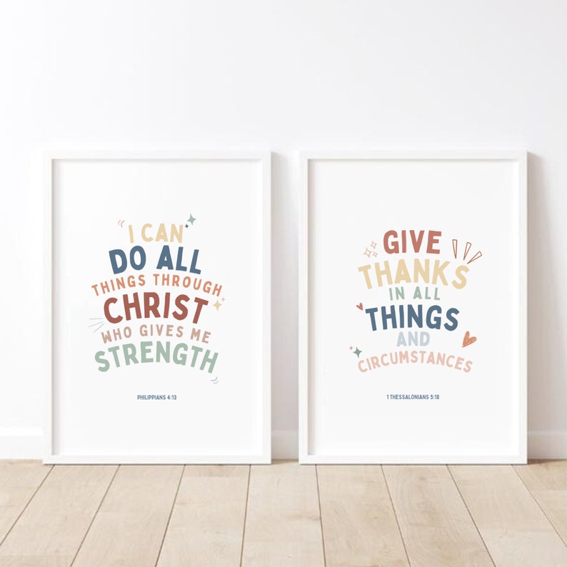 May include: Two white framed prints with inspirational quotes. The left print features the quote "I can do all things through Christ who gives me strength" with the scripture reference Philippians 4:13. The right print features the quote "Give thanks in all things and circumstances" with the scripture reference 1 Thessalonians 5:18.