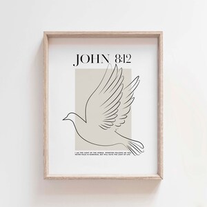 May include: A printable wall art design featuring a minimalist line drawing of a dove with outstretched wings on a beige background. The text "JOHN 8:12" is above the dove and the text "I AM THE LIGHT OF THE WORLD. WHOEVER FOLLOWS ME WILL NEVER WALK IN DARKNESS, BUT WILL HAVE THE LIGHT OF LIFE." is below the dove.