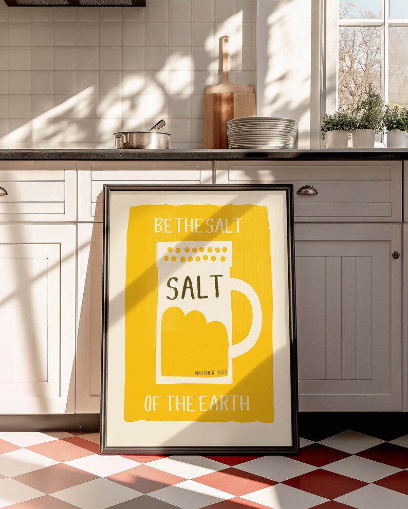 May include: A framed print with a yellow background and a white salt shaker illustration. The text reads "Be the salt", "Salt", "Matthew 5:13", and "Of the earth".