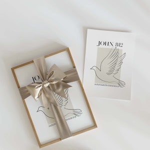 May include: A framed print with a dove illustration and the text "JOHN 8:12"  "I am the light of the world, whoever follows me will never walk in darkness, but will have the light of life."