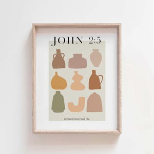 May include: A framed print with a beige background featuring abstract shapes of various colored vases. The text "JOHN 2:5" is at the top of the print and the text "DO WHATEVER HE TELLS YOU." is at the bottom.