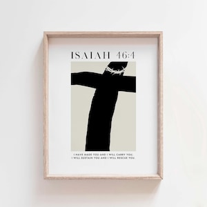 May include: A framed print with a black and white illustration of a cross with a crown of thorns. The text "ISALAH 46:4" is at the top of the print. The text "I HAVE MADE YOU AND I WILL CARRY YOU I WILL SUSTAIN YOU AND I WILL RESCUE YOU." is at the bottom of the print.