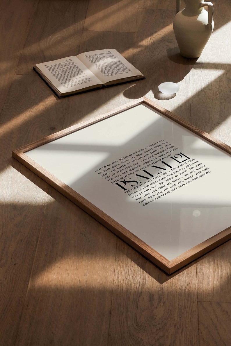 May include: A framed print with a white background and black text. The text is a passage from Psalm 121, which reads: "I lift up my eyes to the mountains - where does my help come from? My help comes from the Lord, the Maker of heaven and earth. He will not let your foot slip; He who watches over Israel will neither slumber nor sleep. The Lord watches over you - the Lord is your shade at your right hand; the sun will not harm you by day, nor the moon by night. The Lord will keep you from all harm; He will watch over your life: The Lord will watch over your coming and going both now and forevermore."