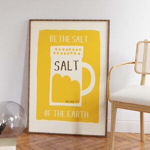 May include: A yellow poster with a white salt shaker illustration and the text "Be the salt, Salt, Matthew 5:13, of the earth".