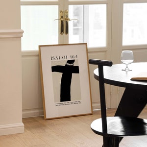 May include: A framed print with a black and white illustration of a cross with a crown of thorns. The text "ISAIAH 46:4" is at the top of the print. The text below the illustration reads "I have made you and I will carry you. I will sustain you and I will rescue you."