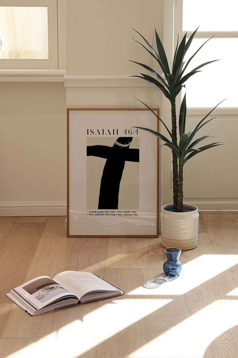 May include: A framed print with a black and white illustration of a cross with a crown of thorns. The print has the text "ISAIAH 46:4" and the quote "I have made you and I will carry you. I will sustain you and I will rescue you."