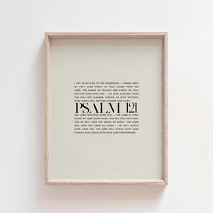 May include: A beige printable wall art print with a black frame. The print features a white background with black text that reads "I lift up my eyes to the mountains - where does my help come from? My help comes from the Lord, the maker of heaven and earth. He will not let your foot slip - he who watches over you will not slumber, indeed, he who watches over Israel will neither slumber nor sleep. Psalm 121. The Lord watches over you - the Lord is your shade at your right hand, the sun will not harm you by day, nor the moon by night. The Lord will keep you from all harm - he will watch over your life. The Lord will watch over your coming and going both now and forevermore."