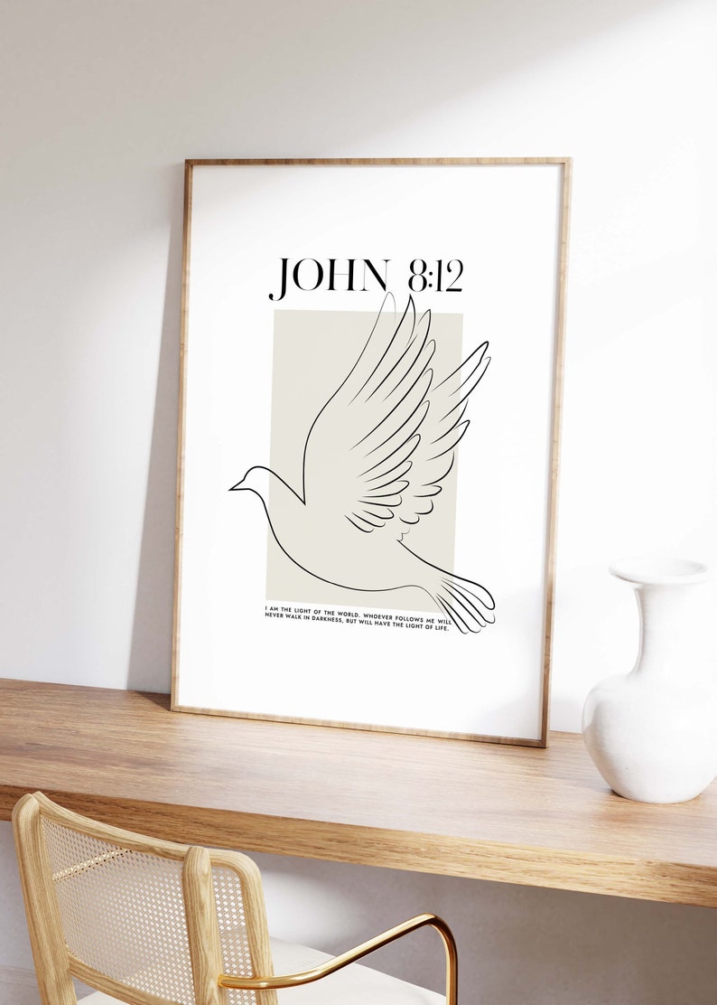 May include: A minimalist printable wall art design featuring a white dove with outstretched wings, a beige background, and the text "JOHN 8:12" in black. The quote below the dove reads "I am the light of the world. Whoever follows me will never walk in darkness, but will have the light of life."
