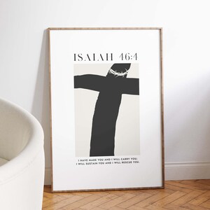 May include: A framed print with a black and white illustration of a cross with a crown of thorns. The text "ISAIAH 46:4" is at the top of the print. The text below the illustration reads "I HAVE MADE YOU AND I WILL CARRY YOU; I WILL SUSTAIN YOU AND I WILL RESCUE YOU."