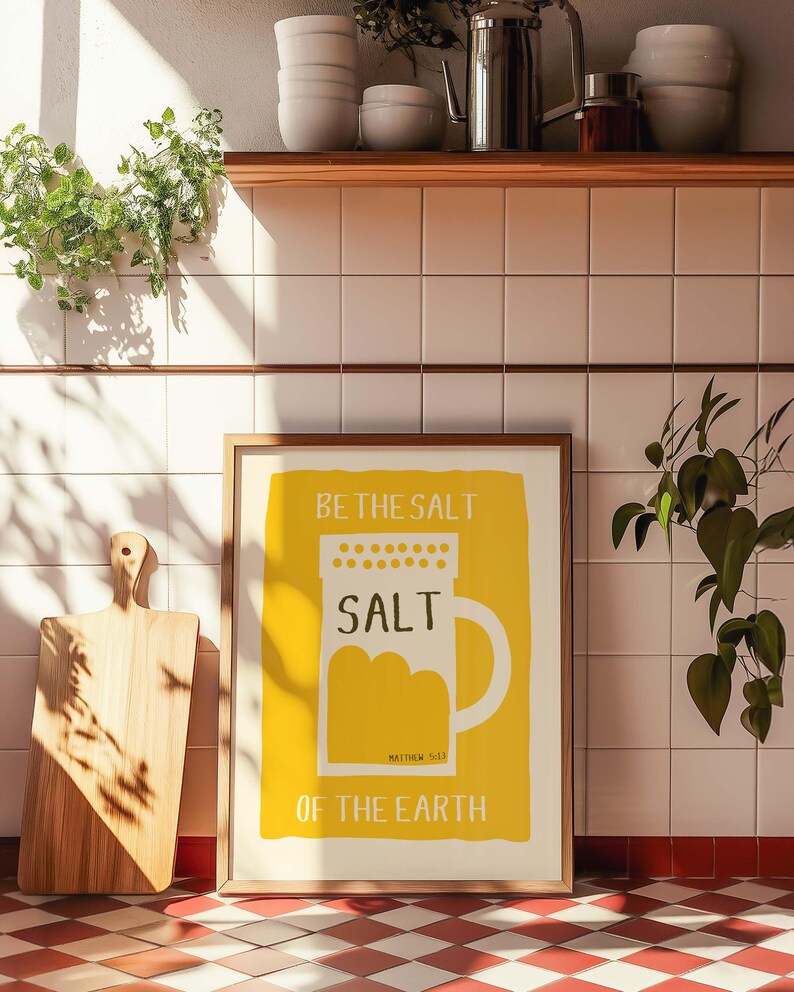 May include: A framed print with a yellow background and white text that reads "Be the salt, Salt, Matthew 5:13, Of the Earth". The print features a stylized illustration of a salt shaker.