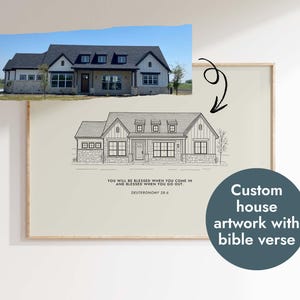 May include: A black and white line drawing of a house with a bible verse, "You will be blessed when you come in and blessed when you go out. Deuteronomy 28:6", printed below the house. The drawing is framed in a light wood frame and is hanging on a white wall.