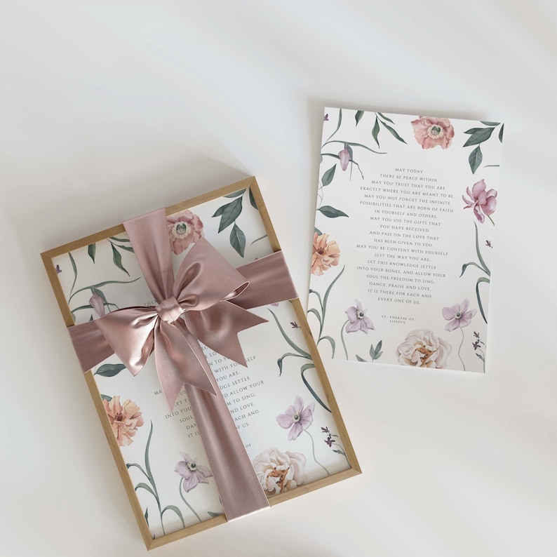May include: A gift box with a floral design and a pink satin ribbon. The box is tied with a bow and contains a card with a floral design and a message about peace within. The card reads "May today there be peace within. May you trust your heart to be exactly where you are right now. May you not forget the infinite possibilities that are always within you. May you and those that you love find the love that has been given to you. May you find the love you have received. And find the love that you may pass on to others. May you be content with yourself and your way. May you settle into the stillness and allow your soul, your mind, and your heart to count the blessings. May it there be peace and love, grace, praise and time. It is there for each of us. Every one of us."