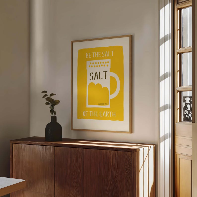 May include: A yellow and white print with the text "Be the salt of the earth" and a stylized image of a salt shaker.