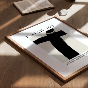 May include: A framed print with a black silhouette of a person on a cross with a crown of thorns. The text "ISAIAH 46:4" is at the top of the print. The text below the image reads "I HAVE MADE YOU AND I WILL CARRY I WILL SUSTAIN YOU AND I WILL RES"