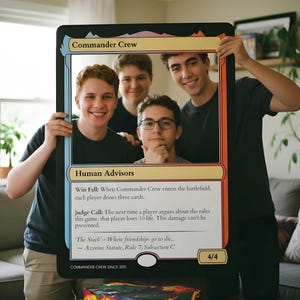 May include: A large, rectangular, black-bordered prop designed to resemble a trading card, featuring the text Commander Crew, Human Advisors, and game rules. The card has a central cutout displaying four people, with a Masters set booster box below.