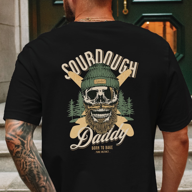 Man wearing black streetwear graphic t shirt 90s aesthetic on the back showing sourdough bread french baguettes with smiling skull. baker shirt sourdough gift streetwear clothing for men. chef baking gifts christmas for sour dough bread baker
