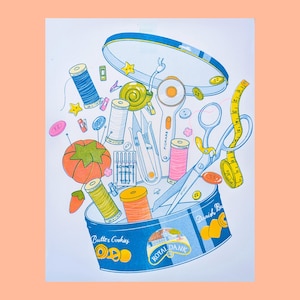 May include: A blue and yellow tin can with the text "Butter Cookies" and "Royal Dansk" on it. The can is open and overflowing with sewing supplies, including spools of thread, buttons, scissors, a tape measure, and a thimble.